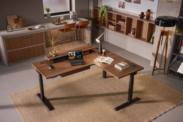 This spacious L-shaped standing desk provides a generous surface for dual monitors, tablets, or paperwork — all while supporting extended use throughout your day, essentially functioning as a corner standing computer desk with room for all your gear.